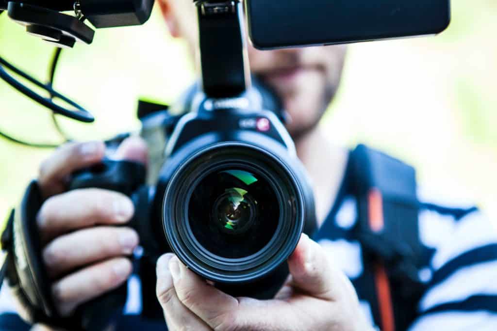 man holding a camera vlogging