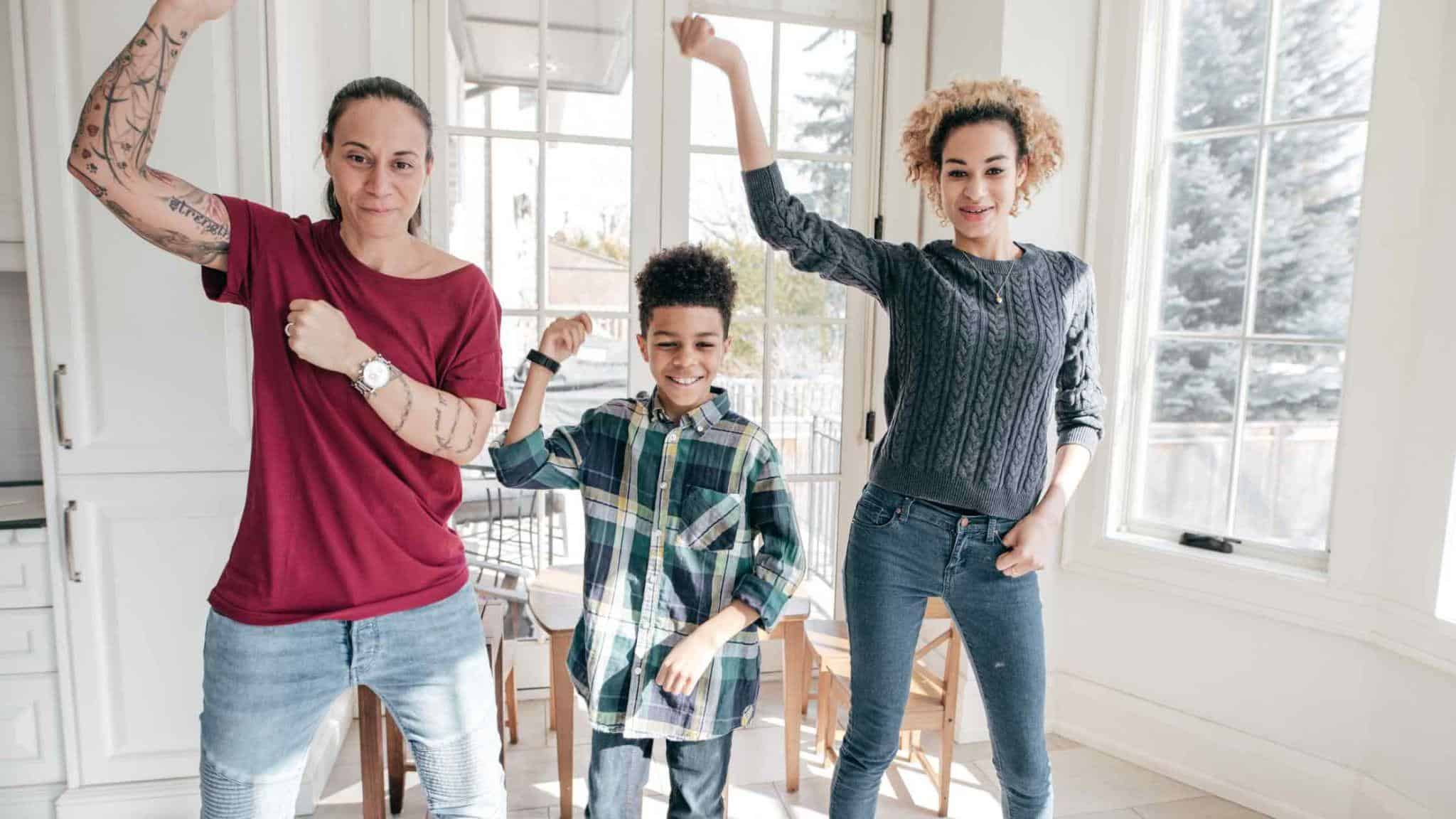 A Mom, daughter and son all dancing together