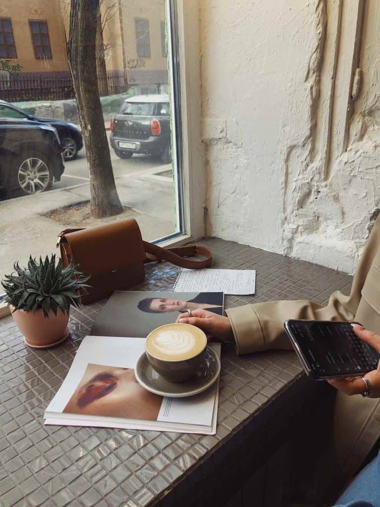 Woman sitting at a cafe thinking how to get back into writing