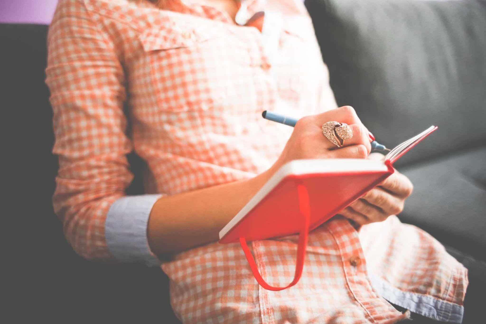 Woman writing in a journal