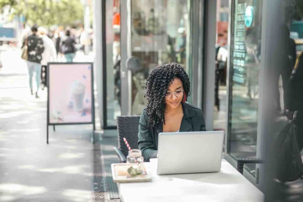 A woman at a cafe blogging