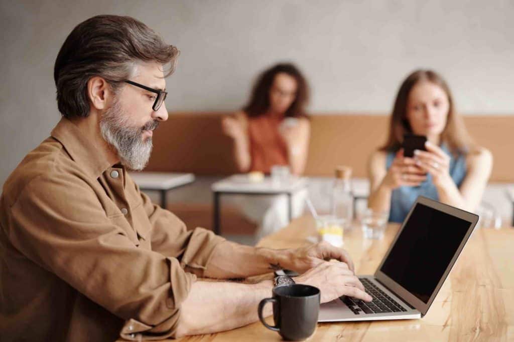 A copywriter writing on his laptop