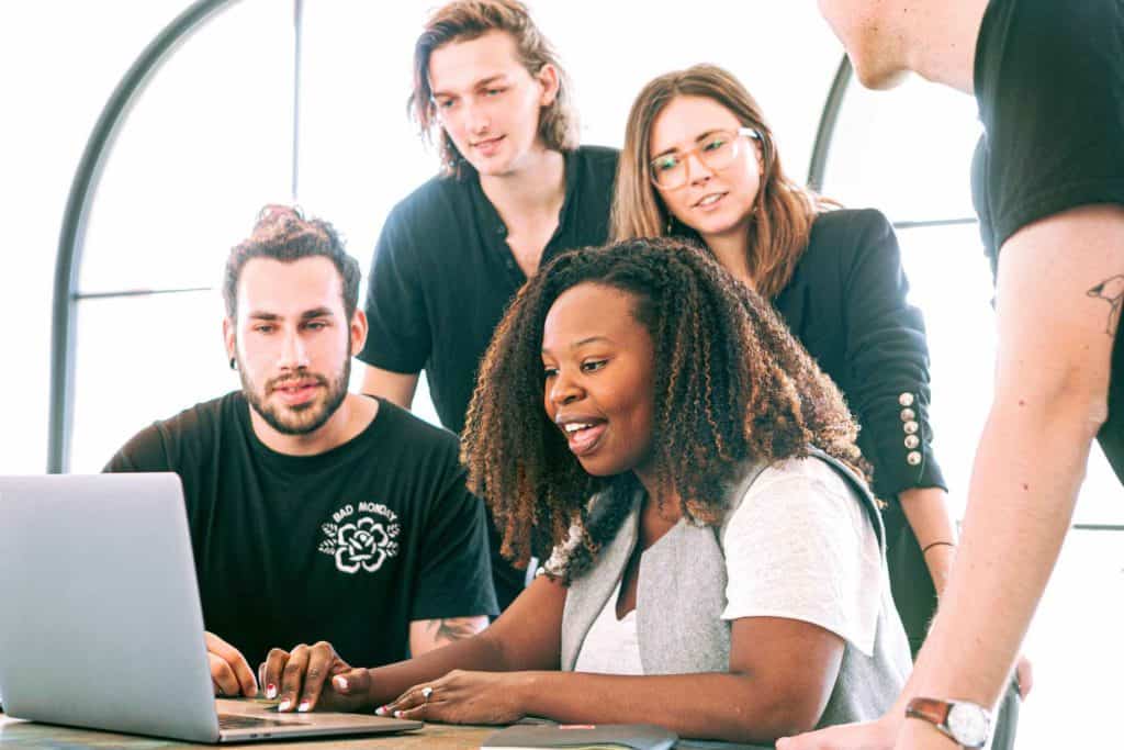 group of people at a digital marketing agency looking at a laptop